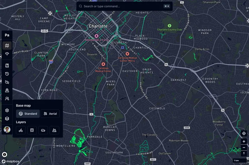 Charlotte at night, with cycle routes traced in green over a dark basemap